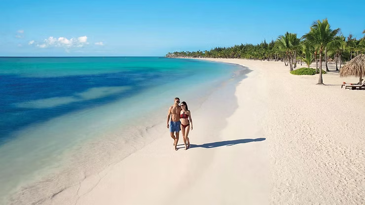 The serene beach at Secrets Cap Cana, ideal for a relaxing day under the sun.